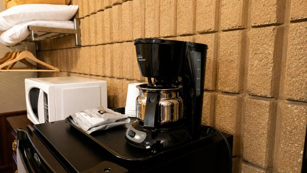 Guest room refreshment area with coffee maker, microwave and refrigerator